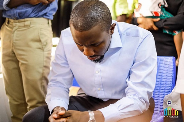 Chukwuma praying in Church